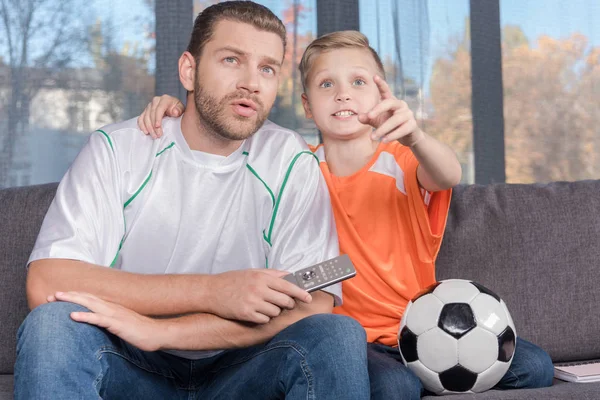 Father and son watching soccer match — Stock Photo