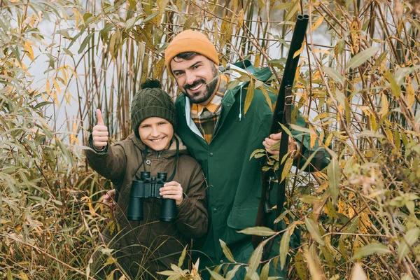 Son showing thumb up at hunt — Stock Photo