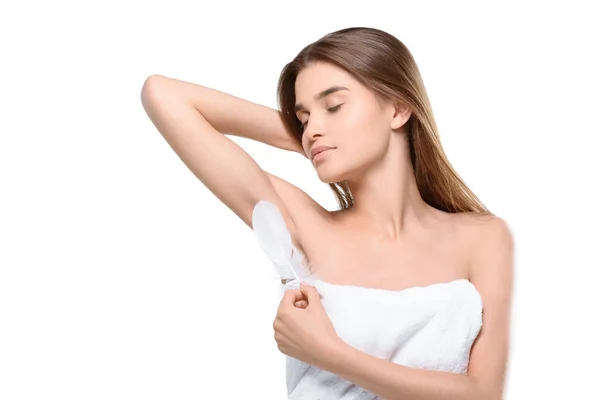 Woman touching armpit with feather — Stock Photo