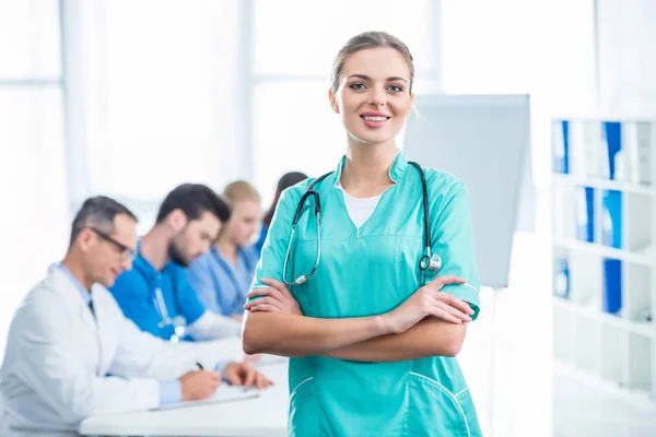 Young nurse with crossed arms — Stock Photo