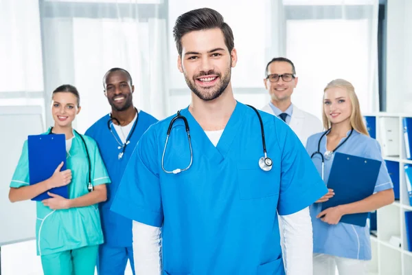 Young doctor with colleagues — Stock Photo