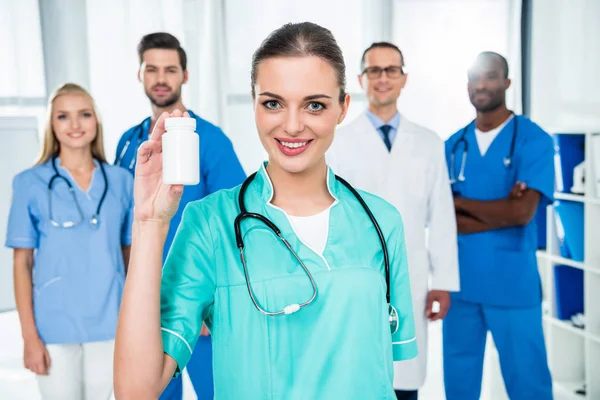 Nurse with jar of pills — Stock Photo