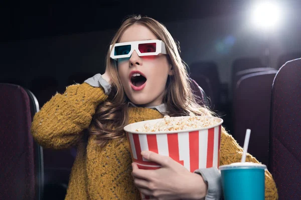 Excited woman in 3d glasses with big basket of popcorn watching movie in cinema — Stock Photo