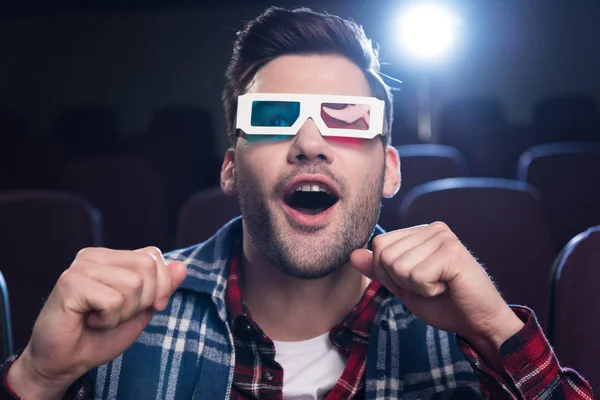 Excited handsome man in 3d glasses watching film in movie theater — Stock Photo