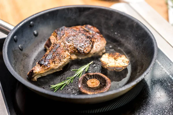 Overhead view of frying meat with mushroom and garlic — Stock Photo