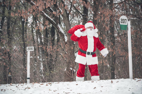 Santa Claus walking with sack on back