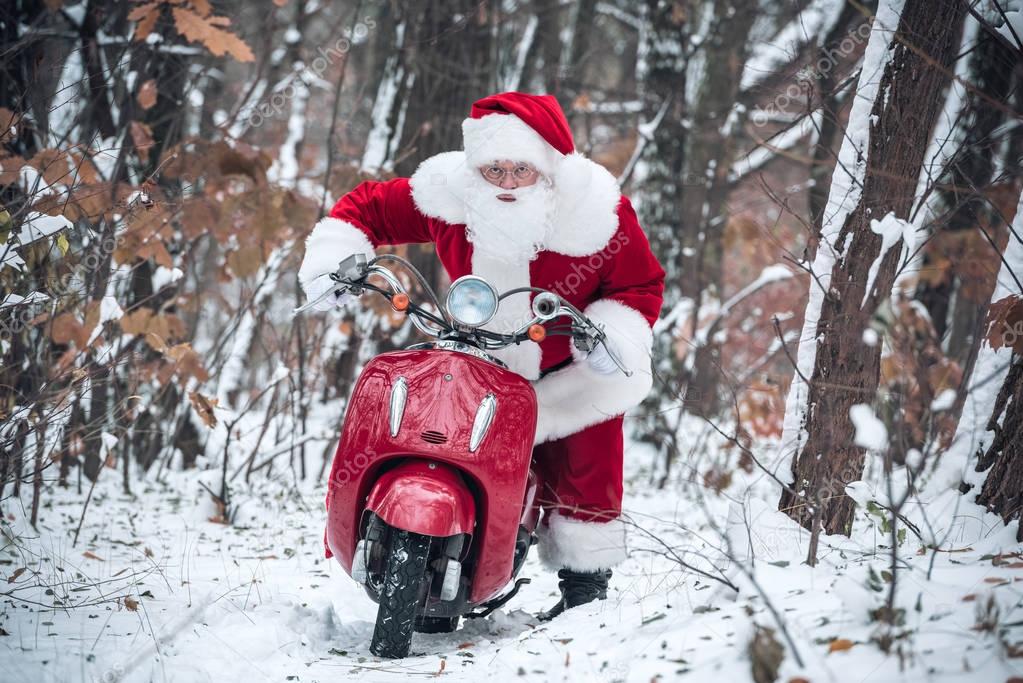 Santa Claus riding red scooter