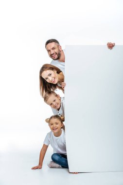 Smiling family holding blank card clipart