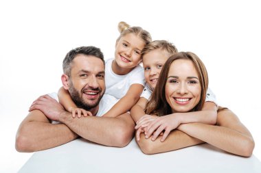 Smiling family in white t-shirts hugging  clipart