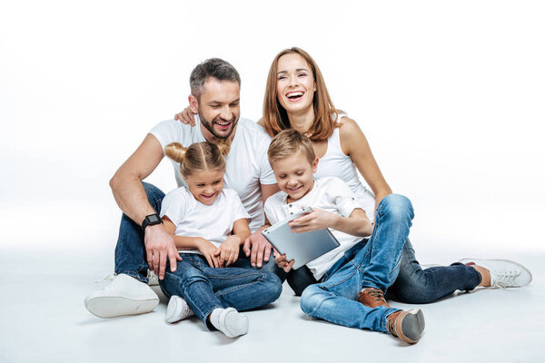 Smiling family using digital tablet