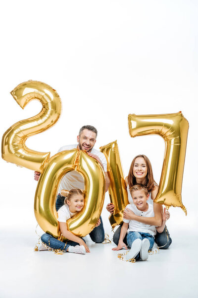 Happy family holding golden balloons 