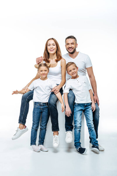 Happy parents with children in white t-shirts 