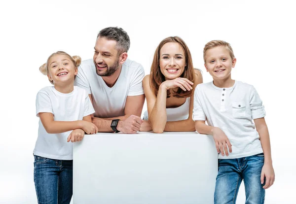 Cheerful family with blank white card — Stock Photo, Image