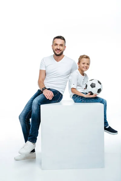 Father and son sitting with soccer ball — Stock Photo, Image