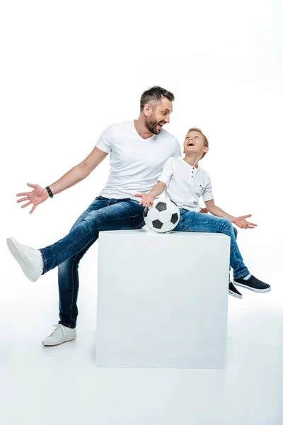 Pai e filho sentados com bola de futebol — Fotografia de Stock