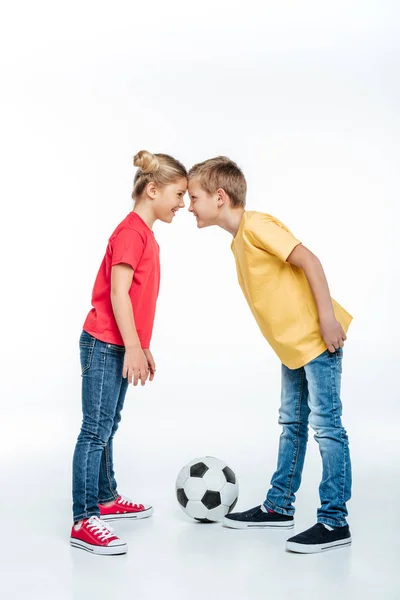 Irmãos de pé com bola de futebol — Fotografia de Stock