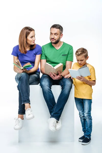 Family with one child reading books — Stock Photo, Image