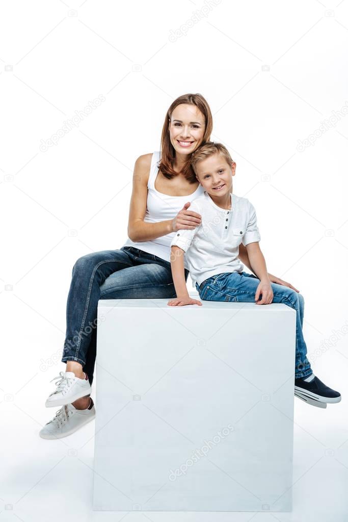 Smiling mother with son sitting togethe