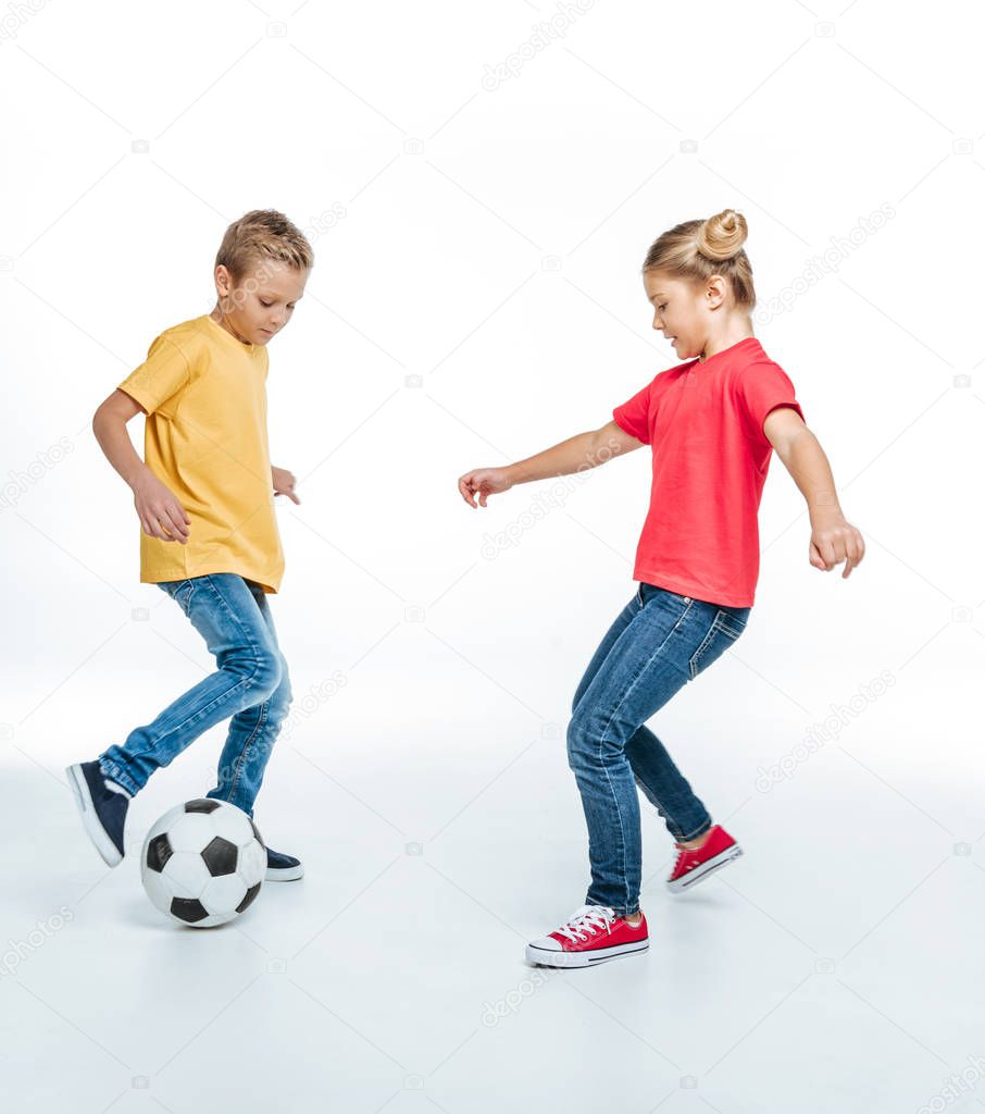siblings playing with soccer ball