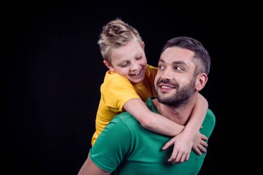 Father piggybacking happy son clipart