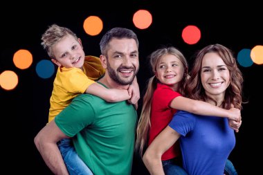 kameraya gülümseyen mutlu bir aile