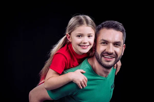 Smiling father piggybacking happy child — Free Stock Photo