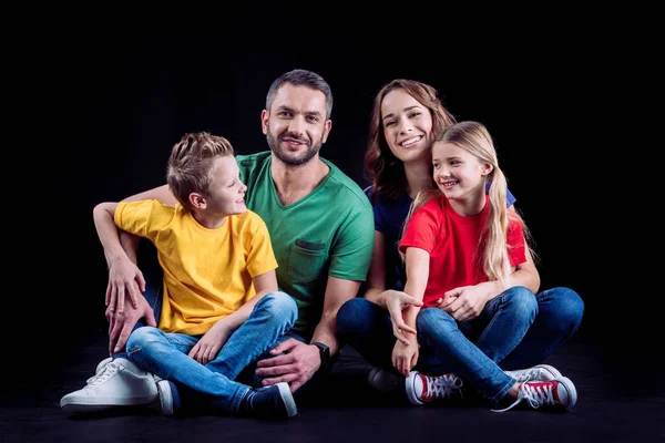 Happy family in colored t-shirts — Stock Photo, Image