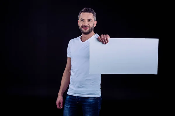 Uomo sorridente con carta bianca in mano — Foto Stock