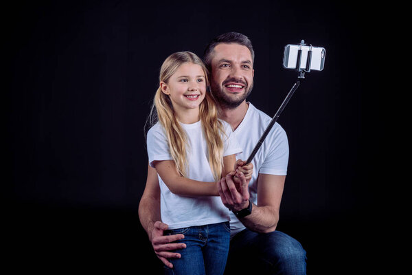 father and daughter taking selfie