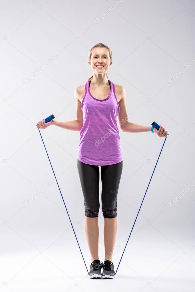 Woman exercising with skipping rope 