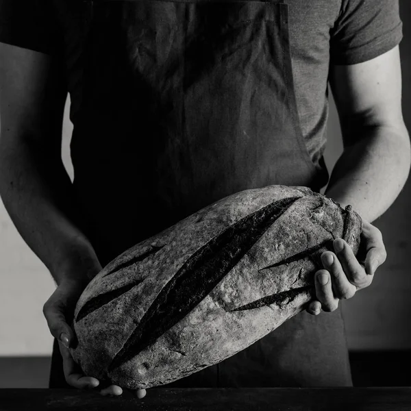 Baker holding bread — Stock Photo, Image