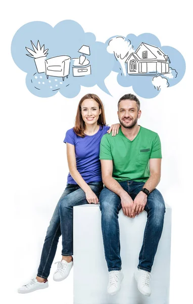 Couple sitting, looking at camera and dreaming — Stock Photo, Image