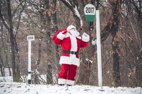 Santa Claus walking with sack on back — Stock Photo