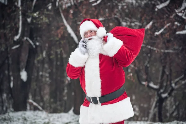 Santa Claus carrying big sack — Stock Photo