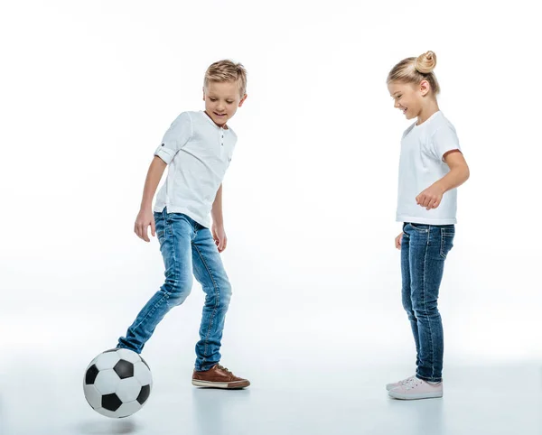 Niños sonrientes jugando con pelota de fútbol - foto de stock