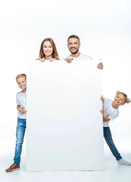 Smiling family holding blank card — Stock Photo