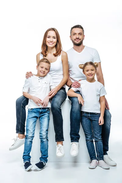 Padres felices con niños en camisetas blancas - foto de stock