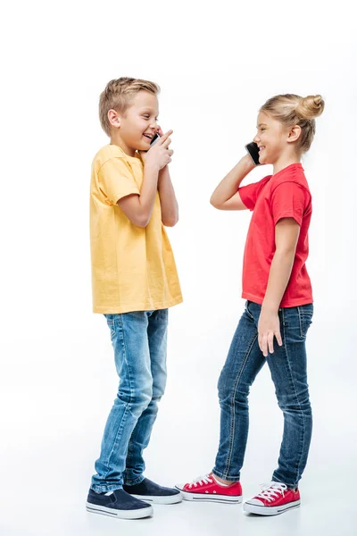 Счастливые дети разговаривают по мобильным телефонам — стоковое фото