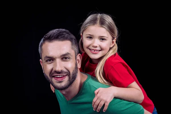 Smiling father piggybacking happy child — Stock Photo