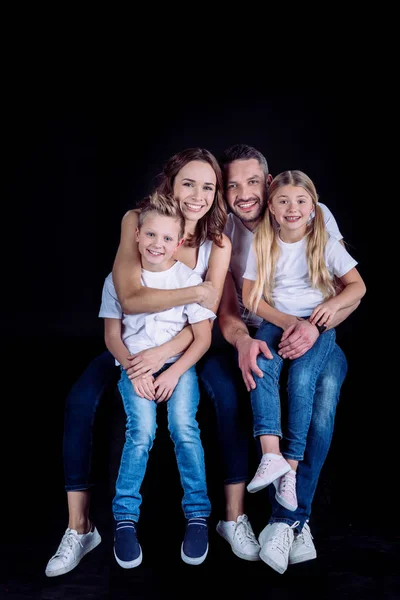 Family sitting together and looking at camera — Stock Photo