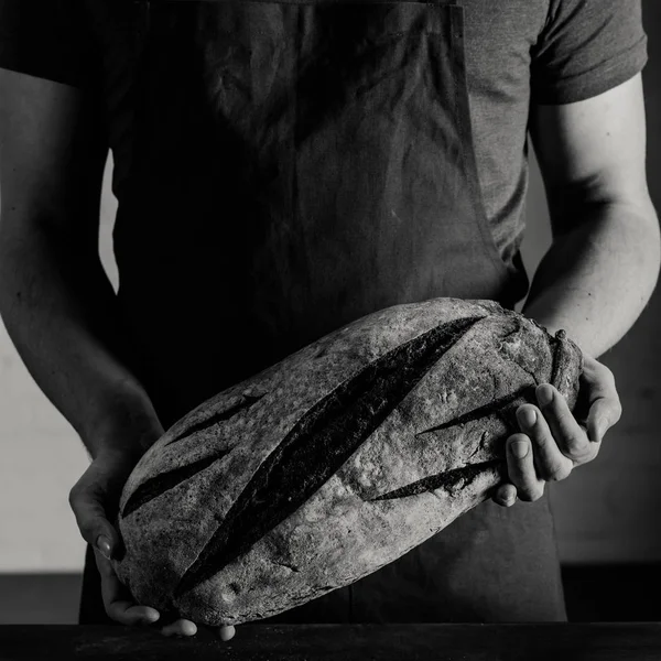 Baker holding bread — Stock Photo