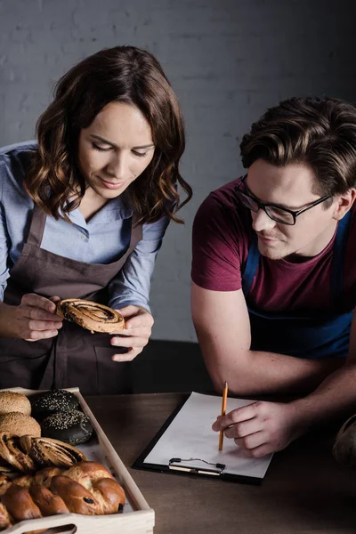 Bakers examining pastries — Stock Photo
