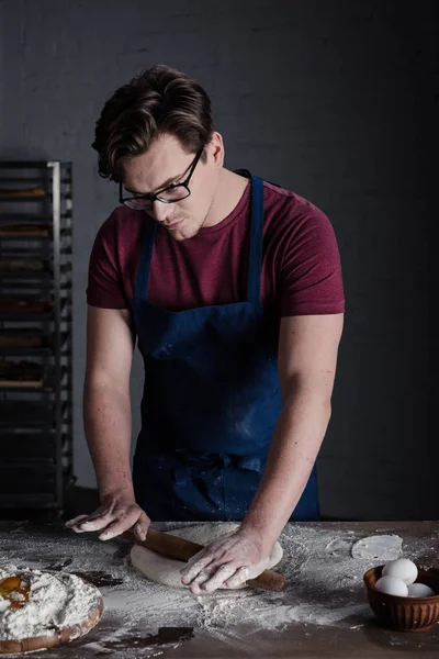 Baker rolling dough — Stock Photo