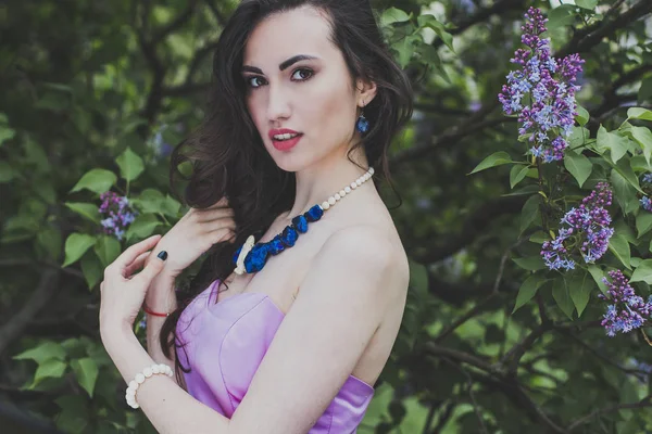 beautiful girl in a lilac garden
