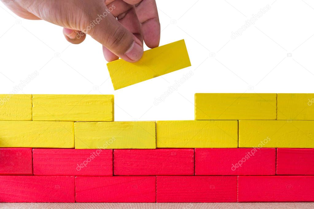 Concept of building success foundation, Hand on the last yellow 
