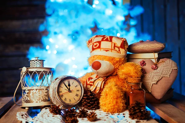Toy bear, cacao, alarm clock and cones