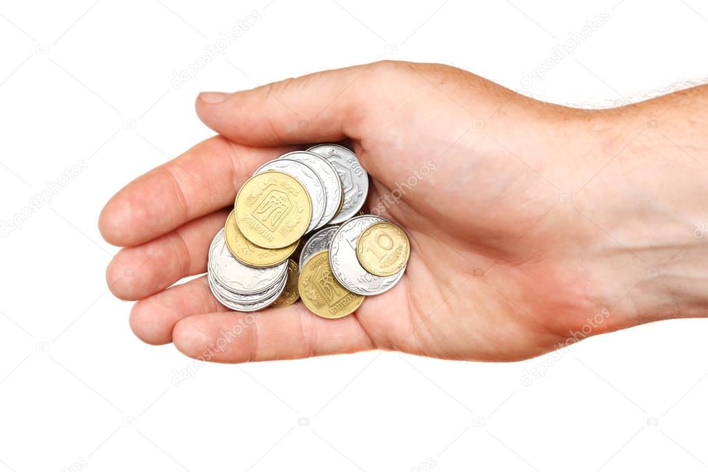 A handful of coins in the palm of a hand, isolated.