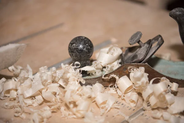 Wood shavings. Planing a tree. Work with a planer. Tools.