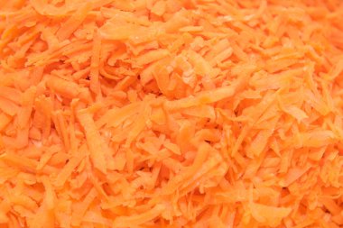 arka planda rendelenmiş havuç. Havuçlar yakın plan. İyi rendelenmiş havuçlar. havuç dokusu. 