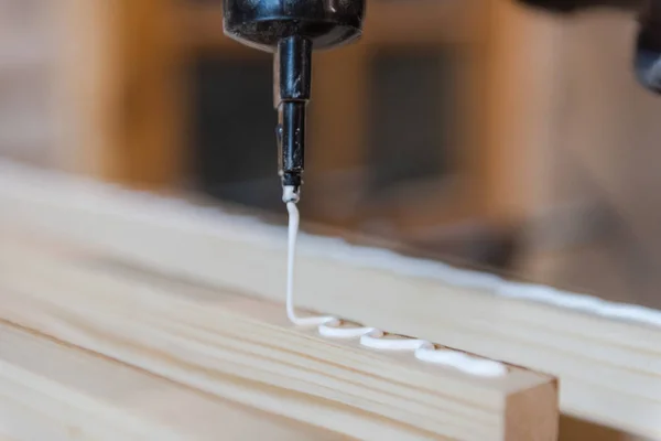 apply glue to the tree. glue the wooden board. glue the wood worktop.